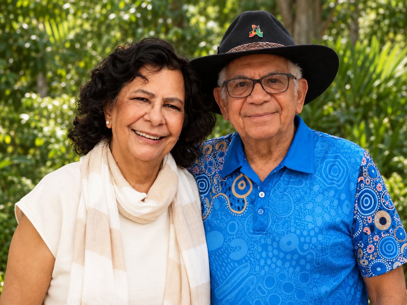 Aunty Pat Williams and Uncle Bill Lemson side by side in a leafy garden, both smiling.