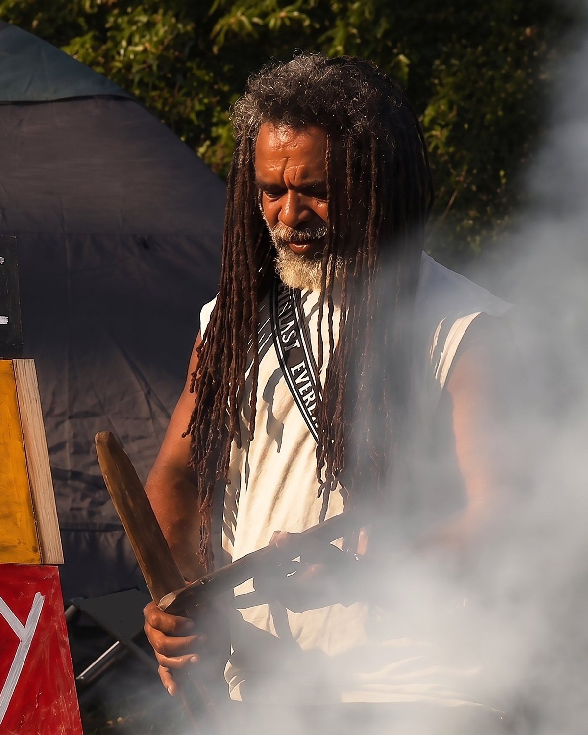 Uncle Derek 'Powder' Oram conducting a smoking ceremony at the Goori Camp Embassy, Barrambin.